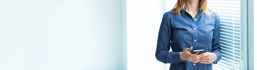 Panorama view of a woman holding a mobile phone