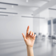 Choosing gesture of person in elegant modern interior in sunshine light