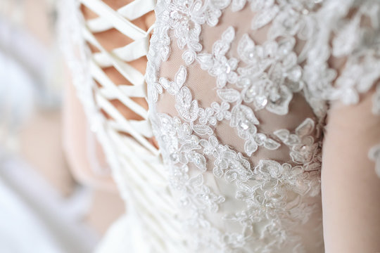 Image of the detailed laces on the back of a wedding dress. Soft fous on lace