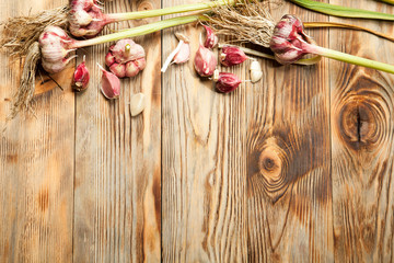 Fresh garlic on old wooden background