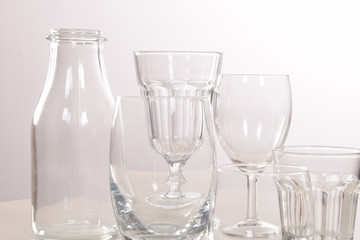Empty crystal glasses and glasses and a bottle