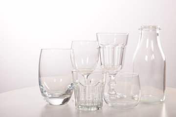Empty crystal glasses and glasses and a bottle