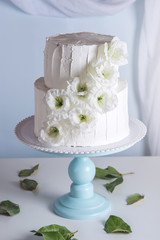 White bunk wedding cake decorated with flowers