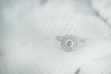 Close up diamond ring on white scarf background with vintage tone.(soft and selective focus)