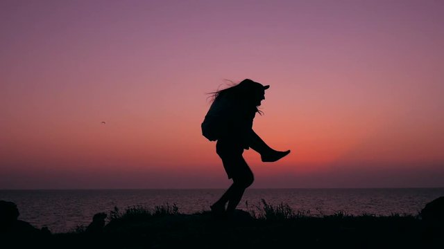 Carefree young hipster couple doing piggyback and turning around on amazing sunset. HD Slowmotion.