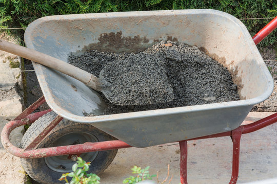 Man is laying paving stones.