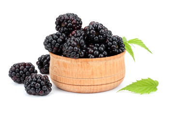 blackberries in wooden bowl isolated on white background