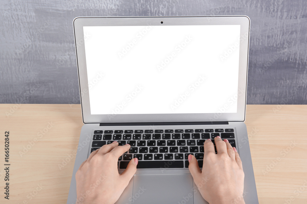 Canvas Prints Young woman working with laptop at table