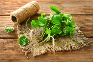 Lemon balm with twine on wooden table