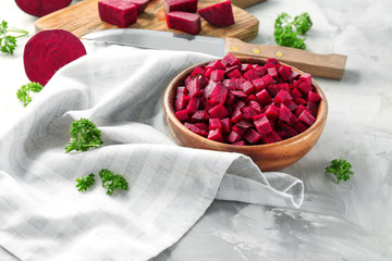 Chopped fresh beet in bowl on light table