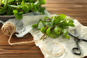 Lemon balm with scissors on wooden table