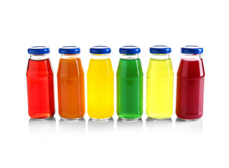 Different juices in bottles on white background