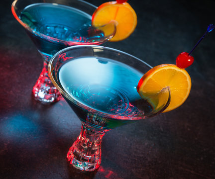 Two colorful blue cocktails in nightclub