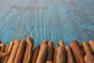 Aromatic cinnamon sticks on wooden surface