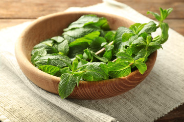 Plate with lemon balm on table