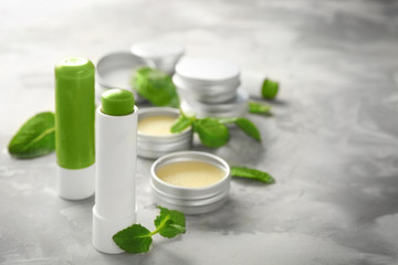 Obraz na płótnie Canvas Cosmetic products with lemon balm on table