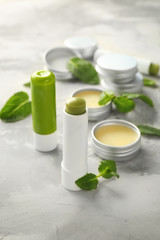 Cosmetic products with lemon balm on table