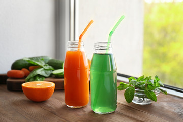Delicious juices in bottles and fruits on window sill