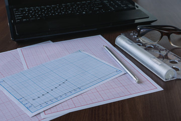 Blueprints. Natural. Mathematical calculations and graphs. Employee on break