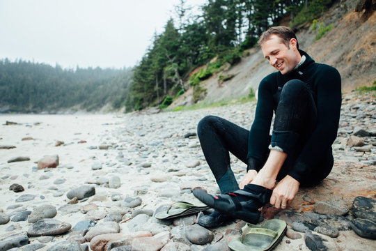 Surfer preparing to surf in cold water
