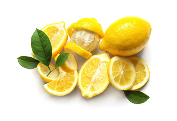 Delicious sliced and peeled lemons with green leaves on white background