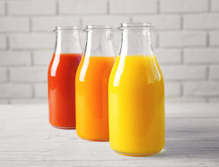 Delicious juices in bottles on table