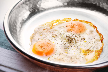 Pan with over hard fried eggs, closeup