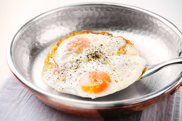 Pan with over hard fried eggs, closeup