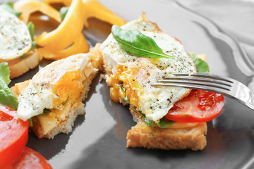 Plate with delicious egg sandwiches and vegetables, closeup