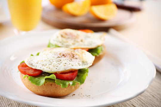 Plate with delicious egg sandwiches on table