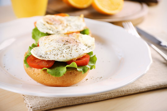Closeup view of plate with delicious egg sandwiches on table