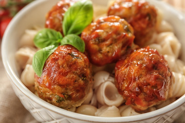 Bowl with turkey meatballs and pasta on table, closeup