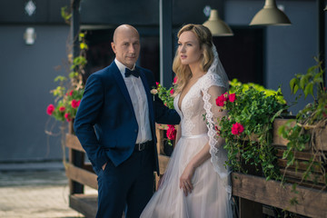 Bride and groom in a city park.