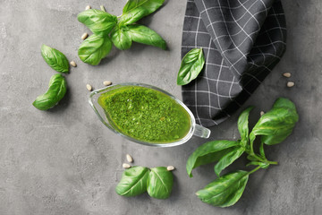 Delicious sauce in gravy boat on grunge background