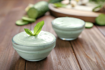 Obraz na płótnie Canvas Delicious yogurt sauce in bowl on wooden background