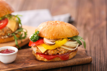 Tasty turkey burger on wooden board
