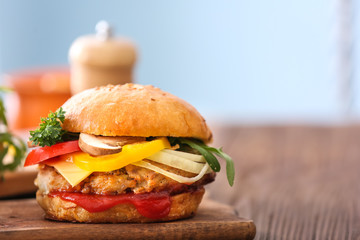 Tasty turkey burger on blurred background