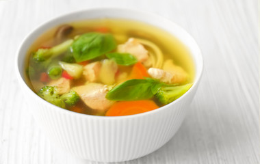 Bowl with delicious turkey soup on wooden table