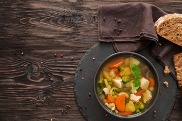 Bowl with delicious turkey soup on table