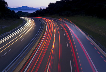Car lights traveling the freeway at dusk