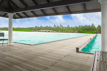 Fototapeta na wymiar Shelter shed and wooden pontoon at sea resort on summer day