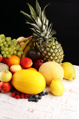 Healthy lifestyle concept. measuring tape sport fitness equipment and healthy food and juice (fruits and vegetables, dumbells, apple, kiwi, pineapple,lemon strawberry