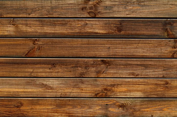 Fototapeta na wymiar Background of natural knotted wood fence. Wooden texture.