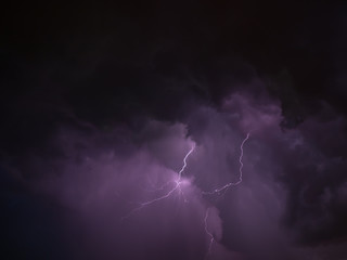 Two lightning and violet skies during thunderstorm
