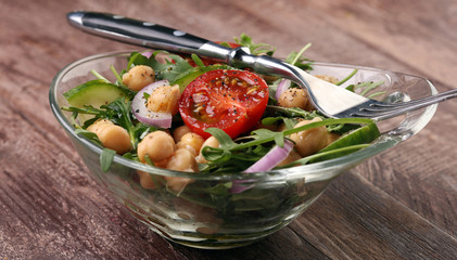 Healthy homemade chickpea and veggies salad, arugula, diet, vegetarian, vegan food, vitamin snack