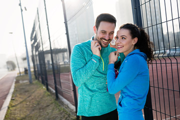 Sportsman and sportswoman flirting outdoor after fitness exercis