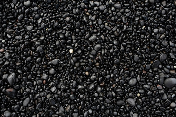 Fototapeta na wymiar Black pebbles on the black stone beach, Vik, Iceland