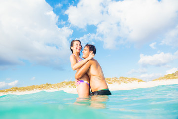 Young Couple Having Fun In The Sea