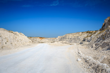Road to quarry. Limestone mining. White rocks