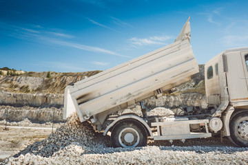 The truck unloads the waste. Mining in the quarry